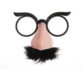 Classic glasses and mustache disguise on white background
