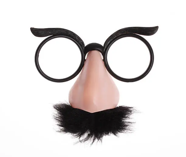 Photo of Classic glasses and mustache disguise on white background