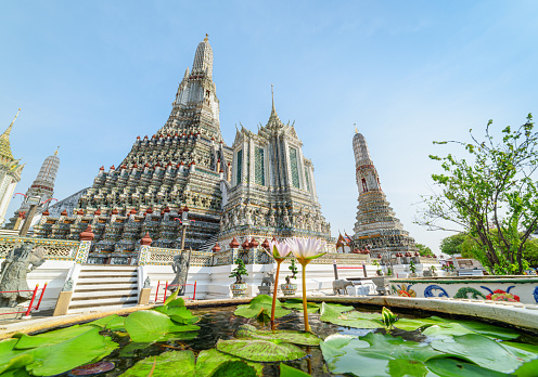 Awesome view of Wat Arun in Bangkok, Thailand. The Buddhist temple is a landmark of Bangkok and a popular tourist attraction of Thailand.