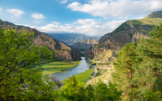 Beautiful landscape with mountains, valley and a river on a sunny summer day with clouds. Dagestan.