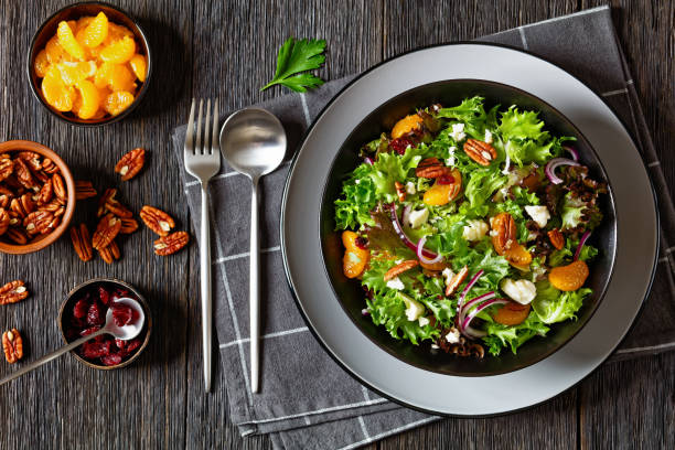 istock Mandarin Orange Salad in black bowl, top view 1735119725