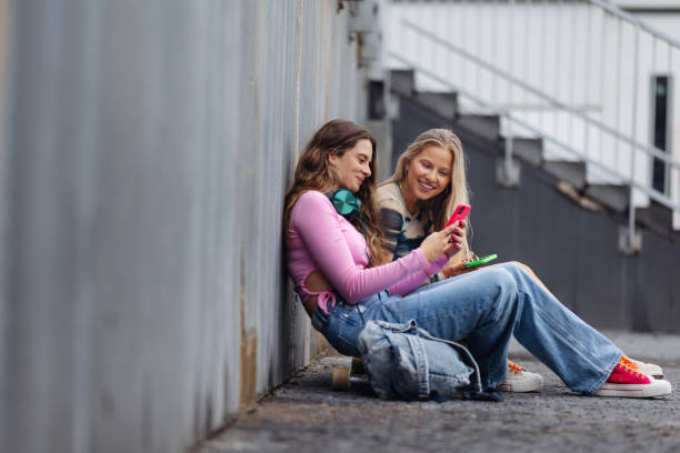 istock Young stylish generation Z girls spending time outdoors after school. 1735127767
