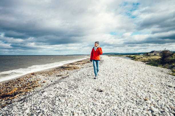 istock Autumn walk on pebble beach, Scotland 1735130427