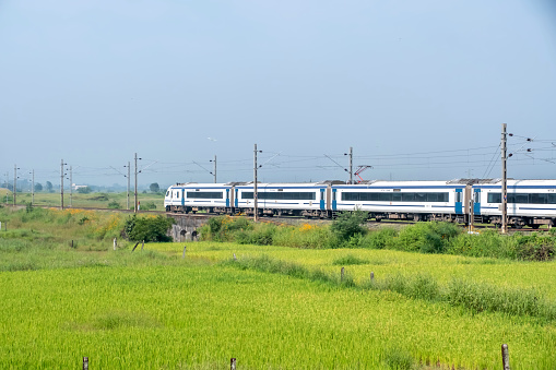 Pune, India -  October 14 2023: The Solapur Mumbai Vande Bharat Express heading towards Mumbai after the end of monsoon season at Kamshet near Pune India.