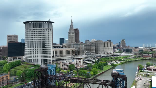 Carter Road Bridge with Cleveland, Ohio skyline in the background. Aerial rising shot above Cuyahoga River.