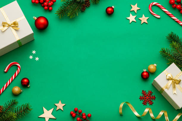 istock Christmas gift boxes and christmas decor with copy space on green background 1735148115