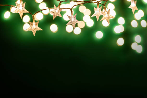 Front view of star shape christmas lights with copy space on dark green background