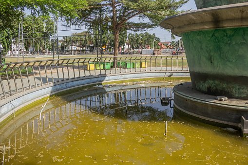 Central pool of the city park is filled with water and is circular