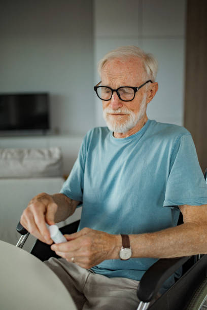 istock Senior man reading the usage instructions on a pill bottle label. 1735156977