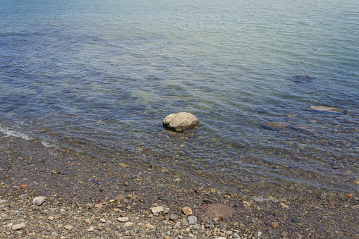 Large rock in the middle of the beach