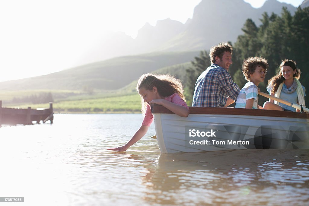 Family in rowboat on lake  Family Stock Photo