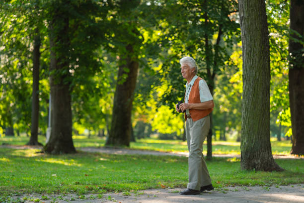 istock Senior man spending free time outdoors in nature, watching forest animals through binoculars. 1735181491