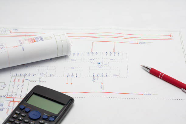 Blueprint with red pen and calculator.