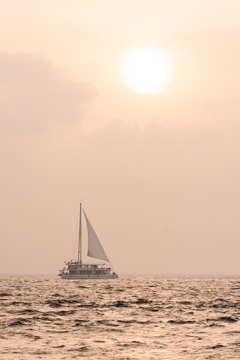 Sail boat in Mirissa Sri Lanka under the sun during sunset. High quality photo