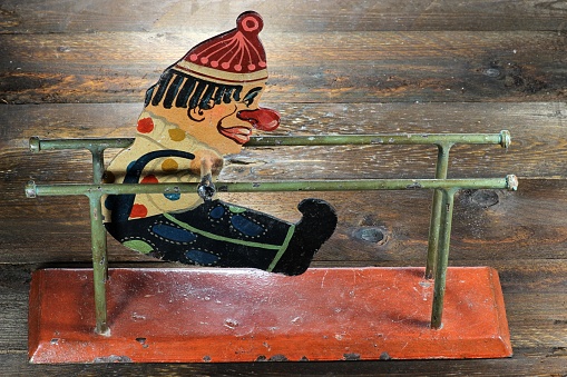 antique parallel bars gymnast toy on wooden background