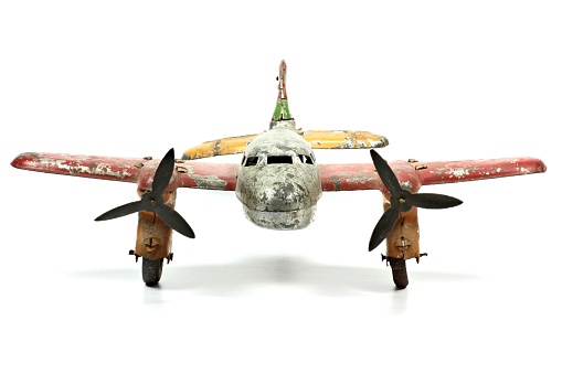 antique tin toy plane isolated on white background