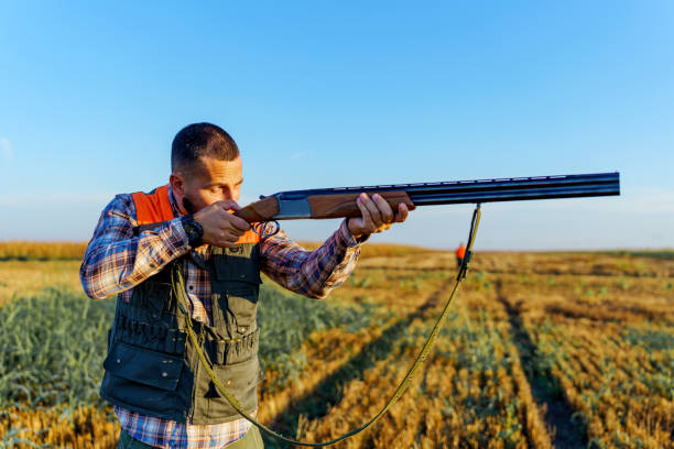 istock Young male hunter holding the rifle steady with his hands, while looking at his prey 1735232979