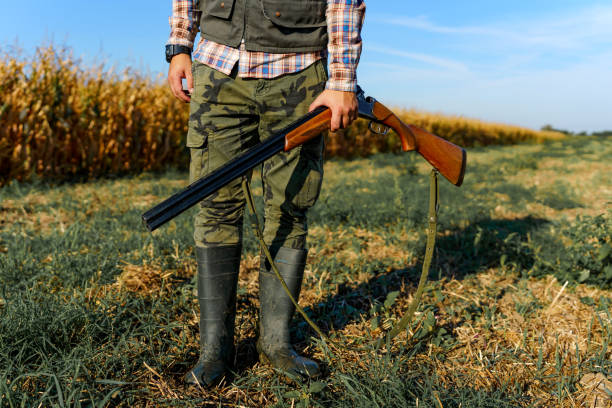 istock Young male hunter holding a shotgun in his hand 1735235130