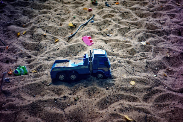 Children's toys in the sandbox, in summer