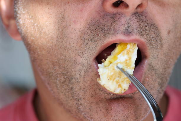 istock Man eating a slice of omelette 1735248970