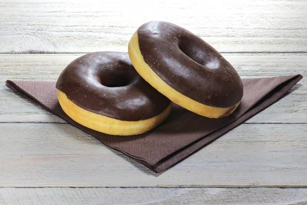 istock chocolate iced donuts with napkin 1735270717