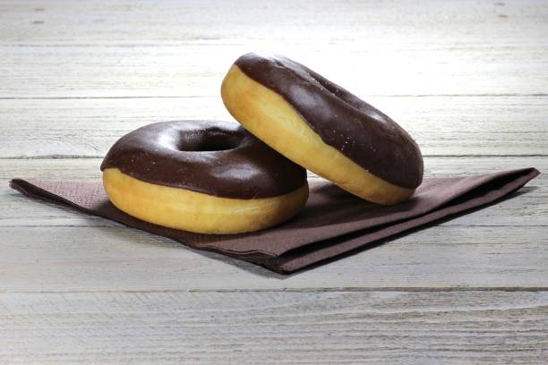 istock chocolate iced donuts with napkin 1735271263
