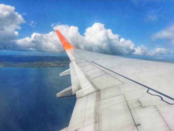 view of the ocean and clouds from the plane window