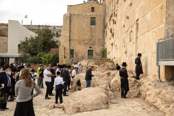 Religious orthodox Jews praying near the wall of the Cave of the Patriarchs in the Old City of Hebron in the West Bank. Hebron, West bank Israel-October 03, 2023:Religious orthodox Jews praying near the wall of the Cave of the Patriarchs in the heart of the Old City of Hebron in the West Bank. father abraham stock pictures, royalty-free photos & images