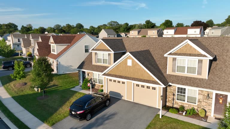 American neighborhood during golden hour sunset. Aerial shot of duplex houses and homes. Drone establishing shot in USA.