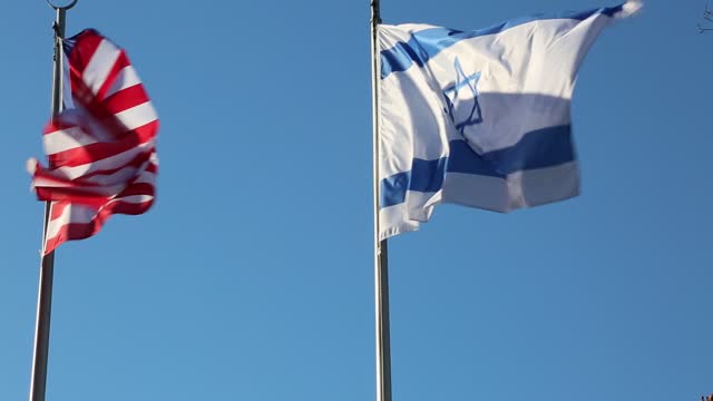 American flag and the Israeli flag with the Star of David waving in the sky
