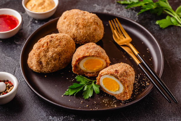 istock Traditional Scotch Eggs on a black plate. 1735293322