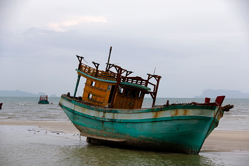Koh Samui, Thailand - July 14, 2018: Old fishing boat on the beach in the morning, Thailand.
