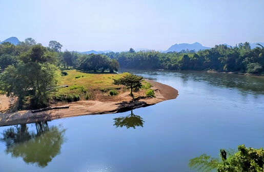 a river with a tree in the foreground.