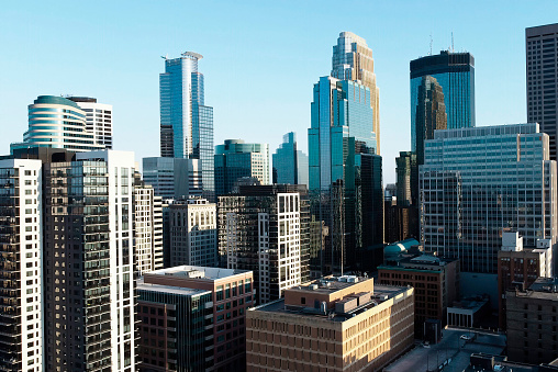 A striking view of Minneapolis unfolds along the east bank of the Mississippi River, showcasing the city's towering skyscrapers and modern architectural prowess