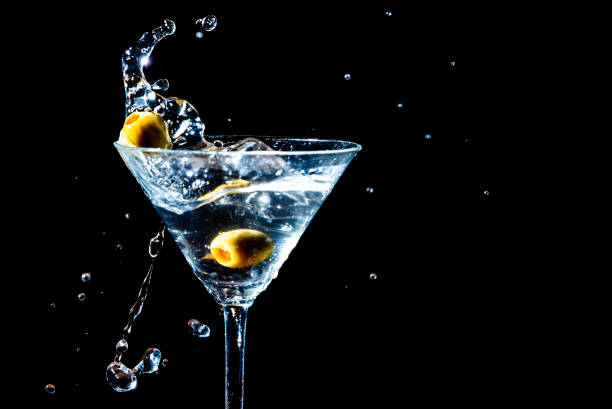 istock Olive splashing into a martini glass 1735323443