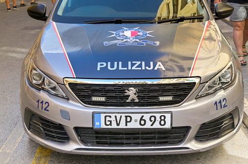 Rabat, Gozo, Malta - 5 August 2023: Close up view of the front of a police patrol car parked in a side street of the city