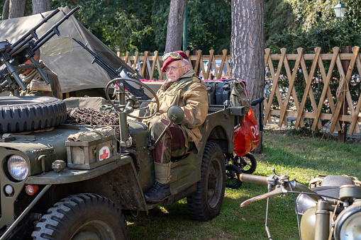 Holt, Norfolk, UK  September 16 2023. Man dressed as a soldier on a WW2 military jeep. Re-enactment at the annual 1940s weekend in Holt, North Norfolk