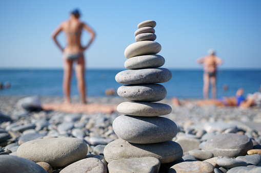 A tower of stones on the beach. Outdoor recreation.