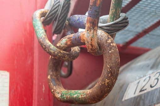 Steel hook and master link, lifting gear for crane operation that using for lifting the heavy object. Industrial operation equipment, selective focus.