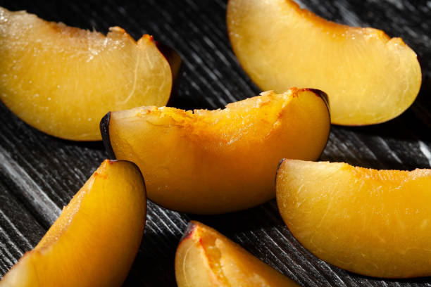 istock sliced plum on wood 1735370373