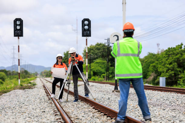istock Engineer use theodolite equipment and Blueprint surveying construction worker on Railway site. 1735374634