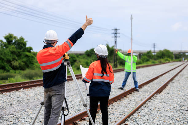 istock Engineer use theodolite equipment and Blueprint surveying construction worker on Railway site. 1735375738