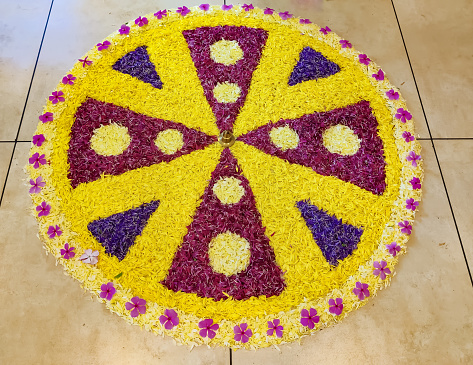 Pookkalam or Flower Art design at the time of Onam Festival inside the home , an art by using lot of different colours and type of  flowers