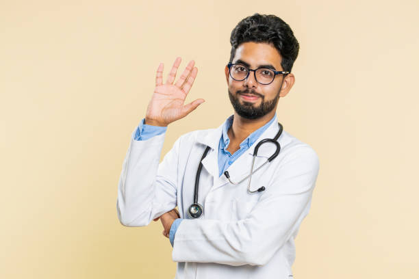 istock Happy doctor man smiling friendly waving hands gesturing hello greeting, goodbye, meeting invitation 1735382389