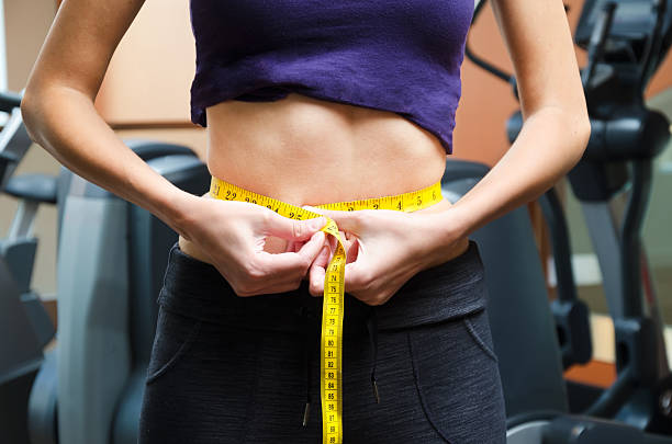 istock Girl is measuring waist 173538353