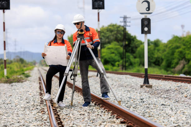 istock Engineer use theodolite equipment and Blueprint surveying construction worker on Railway site. 1735384575