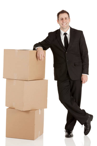 istock Smiling businessman leaning on cardboard boxes 173538699