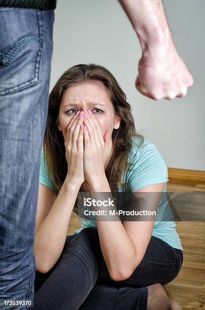 Home Violence Concept Frightened Woman And Mens Fist Stock Photo - Download Image Now