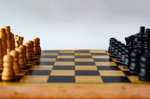 Battle between white and black chess on a chess boar. Strategy and tactics concept