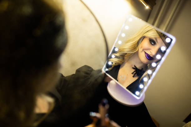 istock Young woman is doing makeup for a Halloween party 1735398409